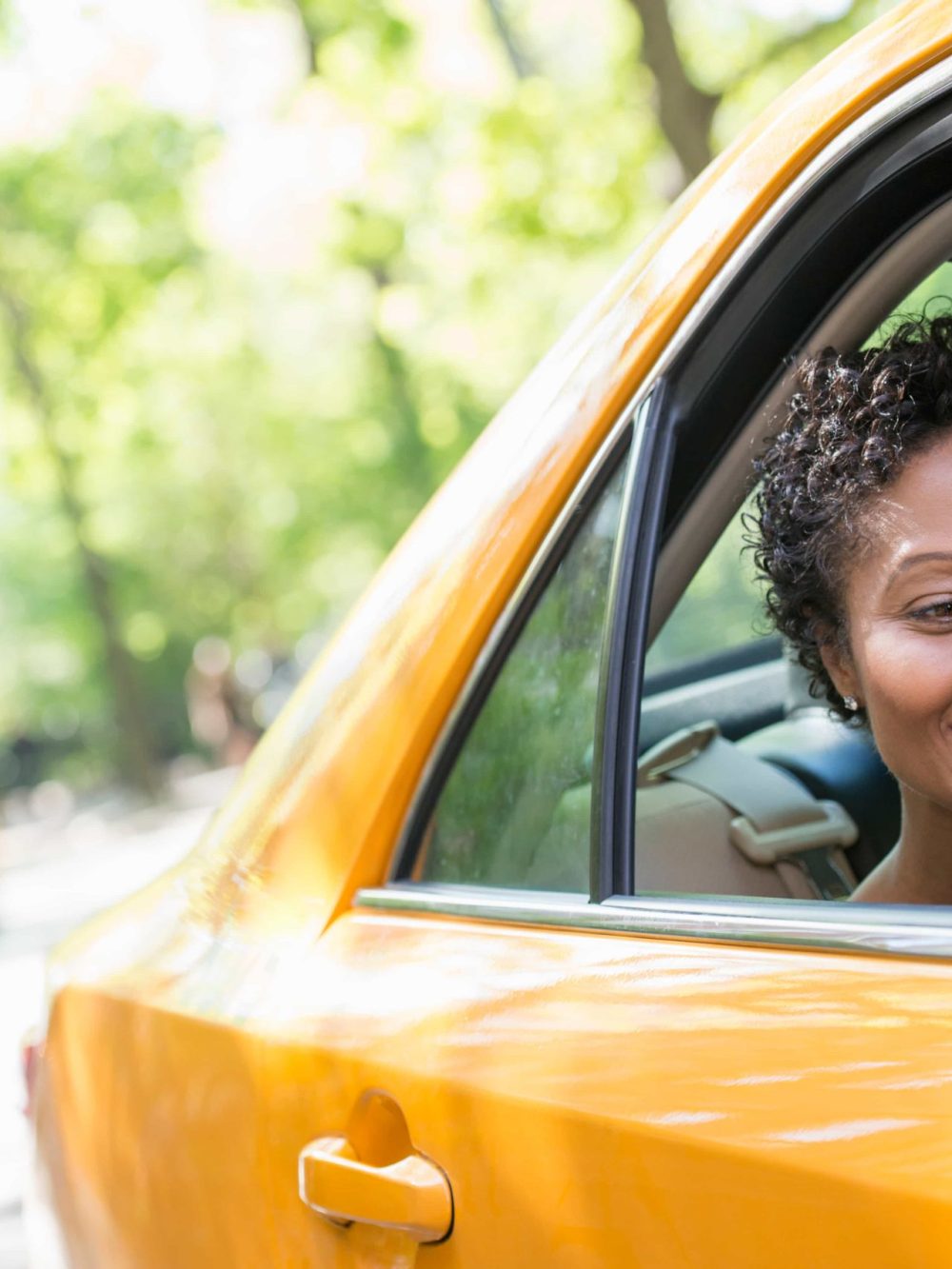 Taxi Latino Carxi a-woman-sitting-in-the-rear-passenger